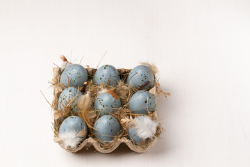 Easter eggs on white background. Blue eggs with feather