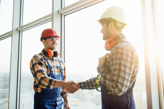 Two business leaders shaking hands over cityscape background. Concept of partnership.