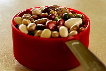 a depth of field shot of dried beans in a measuring cup