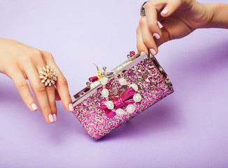 little girl stuff for princess, woman hands holding small cute handbag with jewelry and manicure, luxury lifestyle concept