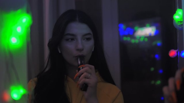 Girl smoke vape, inhaling an e-cigarette, bad habits, mirror, slow motion