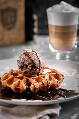 Viennese Waffles with ice cream and coffee. Beautiful picture of dessert with latte coffee. Dessert concept, sweet life. Food photo, copy space, gray background.