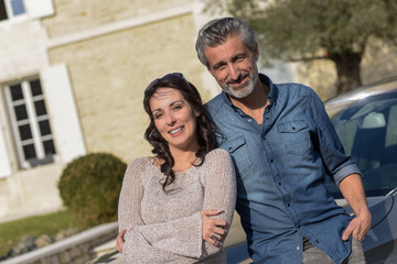 middle-aged couple satisfied with their success