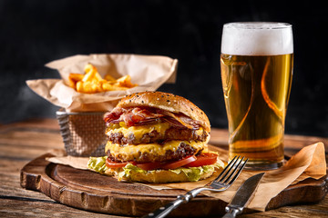 Set of hamburger beer and french fries. A standard set of drinks and food in the pub, beer and...