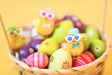 Fototapeta na wymiar Easter chick and painted Easter eggs isolated on yellow background