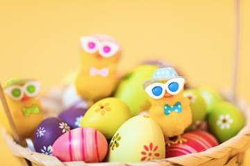Fototapeta na wymiar Easter chick and painted Easter eggs isolated on yellow background