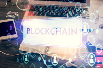 Double exposure of blockchain theme drawings and desk with open notebook background. Concept of...