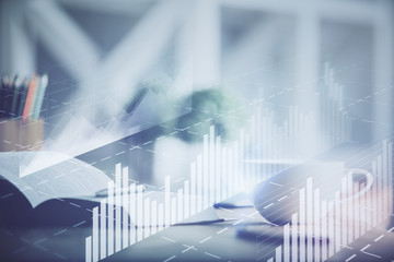 Multi exposure of forex graph drawing and desktop with coffee and items on table background. Concept of financial market trading