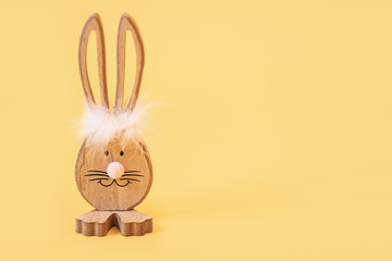 Wooden Easter Bunny, on an isolated yellow background
