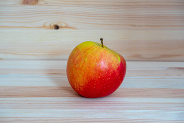 Red fresh apple on wood table