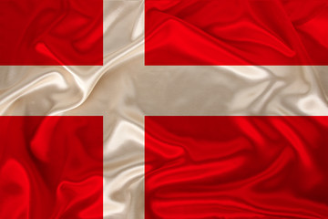 photo of the national flag of Denmark on a luxurious texture of satin, silk with waves, folds and highlights, close-up, copy space, concept of travel, economy and state policy, illustration