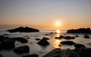 Fototapeta na wymiar the sunset at the background in the atlantic ocean, Punta Ballena, Maldonado, Uruguay
