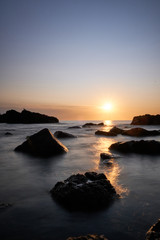 Fototapeta na wymiar the sunset at the background in the atlantic ocean, Punta Ballena, Maldonado, Uruguay