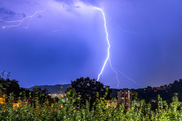 Lightning over the city at the summer storm. Dramatic, breathtaking atmospheric natural...