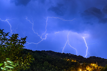 Lightning over the city at the summer storm. Dramatic, breathtaking atmospheric natural...