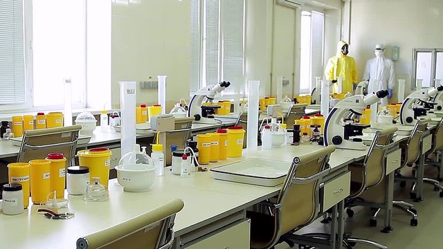 Microscopes and suits of a bacteriological laboratory.