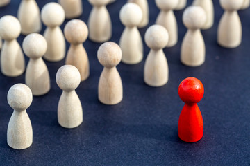 Personal development. Wooden figure in a crowd. Think different.