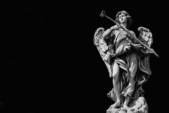 Angel marble statue with sponge, a 17th century baroque masterpiece on Holy Angel Bridge in Rome (Black and White with and copy space)
