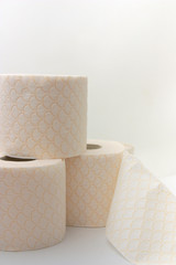 Some toilet paper rolls stacked on a white background