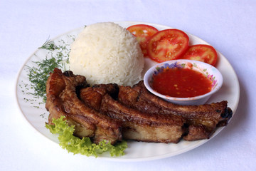 Fried pork ribs with boiled rice, dishes of Russian national cuisine