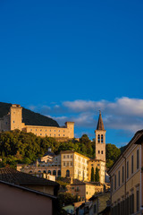 Fototapeta na wymiar The ancient city of Spoleto in Umbria, with it most famous landmarks and sunset golden light (with copy space above)