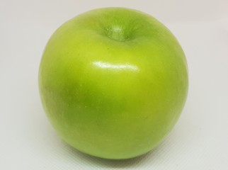 A green apple on a white background