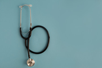 Stethoscope on a blue background. Place for text. Medical concept
