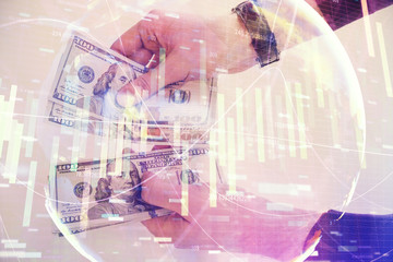 Multi exposure of financial theme drawing hologram and USA dollars bills and man hands. Business concept.