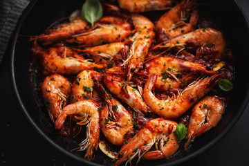 Fried shrimps with spices on pan