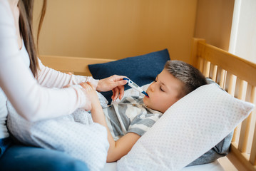 A mother takes care of her child who has a fever and fever. Disease and healthcare