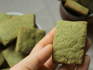 Beautiful and tasty home baked green cookies with matcha tea powder, a sweet dessert for tea time.