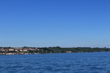Naklejka premium Meersburg city view taken from a passenger boat on Lake Constance raised anchor from Konstanz city in Baden-Wuerttemberg state in Germany.