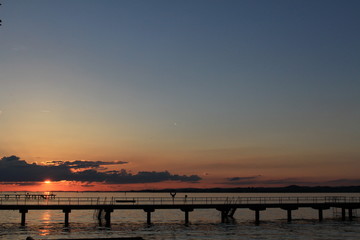Fototapeta premium Sunset over Lake Constance (Bodensee) from the shore of Bregenz in Vorarlberg, Austria. 