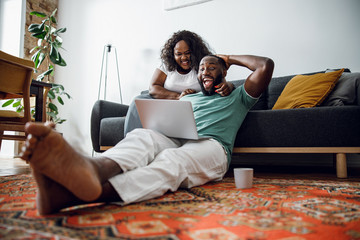 Excited couple watching sports on laptop stock photo