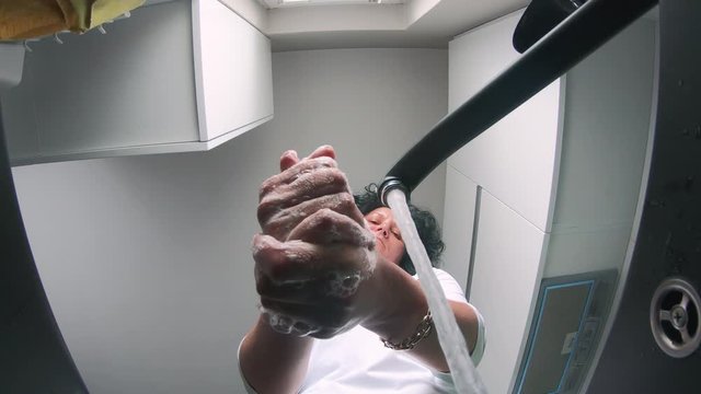 Washing hands rubbing with soap man for winter flu virus prevention, hygiene to stop spreading germs.