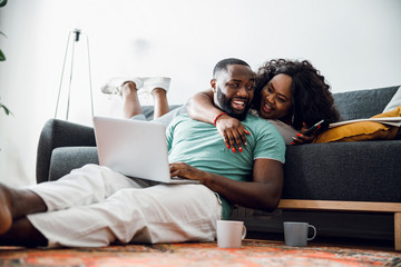 Couple enjoying tea and hugs at home stock photo