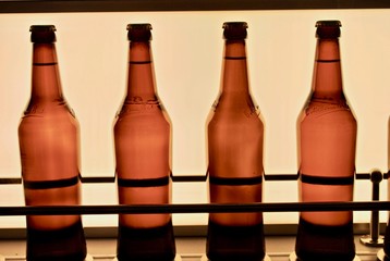 Bitburger beer bottles on a conveyer belt. Bitburger Brewery (Bitburger Brauerei) is a large German brewery founded in 1817 by Johann Wallenborn. 