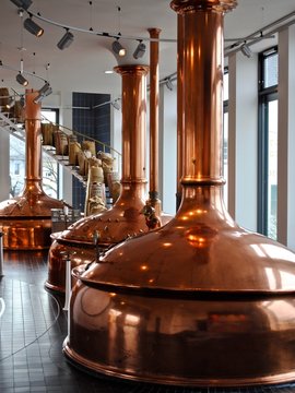 Bitburger Brewery (Bitburger Brauerei) is a large German brewery founded in 1817. Copper brew kettle and spiral stairs filled with malt (Labeled in German: Quality Malt).