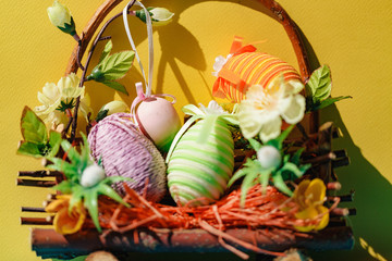 Eggs on a yellow background. Easter. Eggs. Bunny. Painted eggs. Holy day. People. Religion.