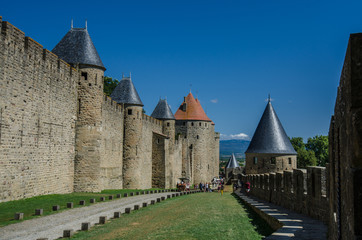 Picturesque walls of medieval  castle with metal roofs observing towers. © AK Media