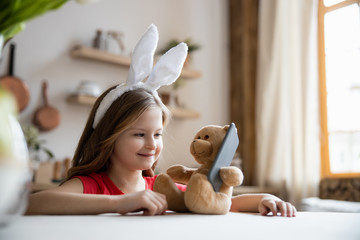 Happy girl playing with teddy bear stock photo