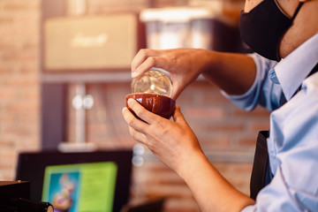 barista making cappuccino. Pouring milk for prepare cup of coffee. Latte art.