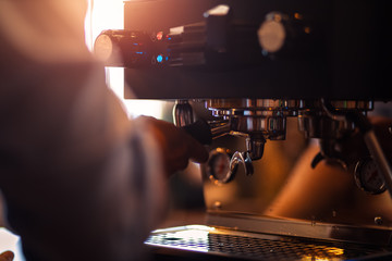 Fototapeta na wymiar Barista making fresh coffee with coffee machine in cafe