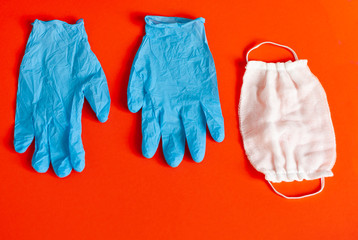 Protection disease. Medical respirator bandage, Electronic thermometer and lab gloves - Virus protection equipment on blue background.COVID East respiratory syndrome coronavirus