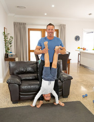 COVID-19 Outrbreak. Father and son exercising together at home during coronavirus quarantine