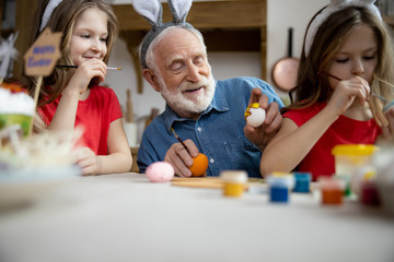 Happy man and girl looking at Easter eggs stock photo