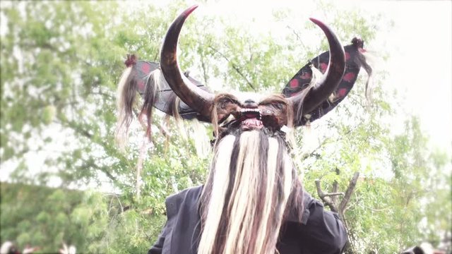 GUANAJUATO, MEXICO - CIRCA OCTOBER 2019: Mexican dancer using a devil mask with a long beard in a public plaza during the International Cervantino Festival.