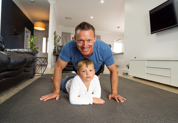 COVID-19 Outrbreak. Father and son exercising together at home during coronavirus quarantine