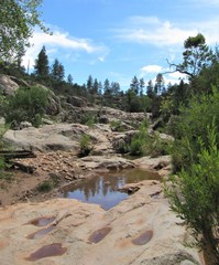 View on the Water Wheel Falls hiking trail located in Payson, Arizona with blue sky and clouds in the background 