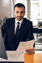 Attractive young businessman working in cozy office